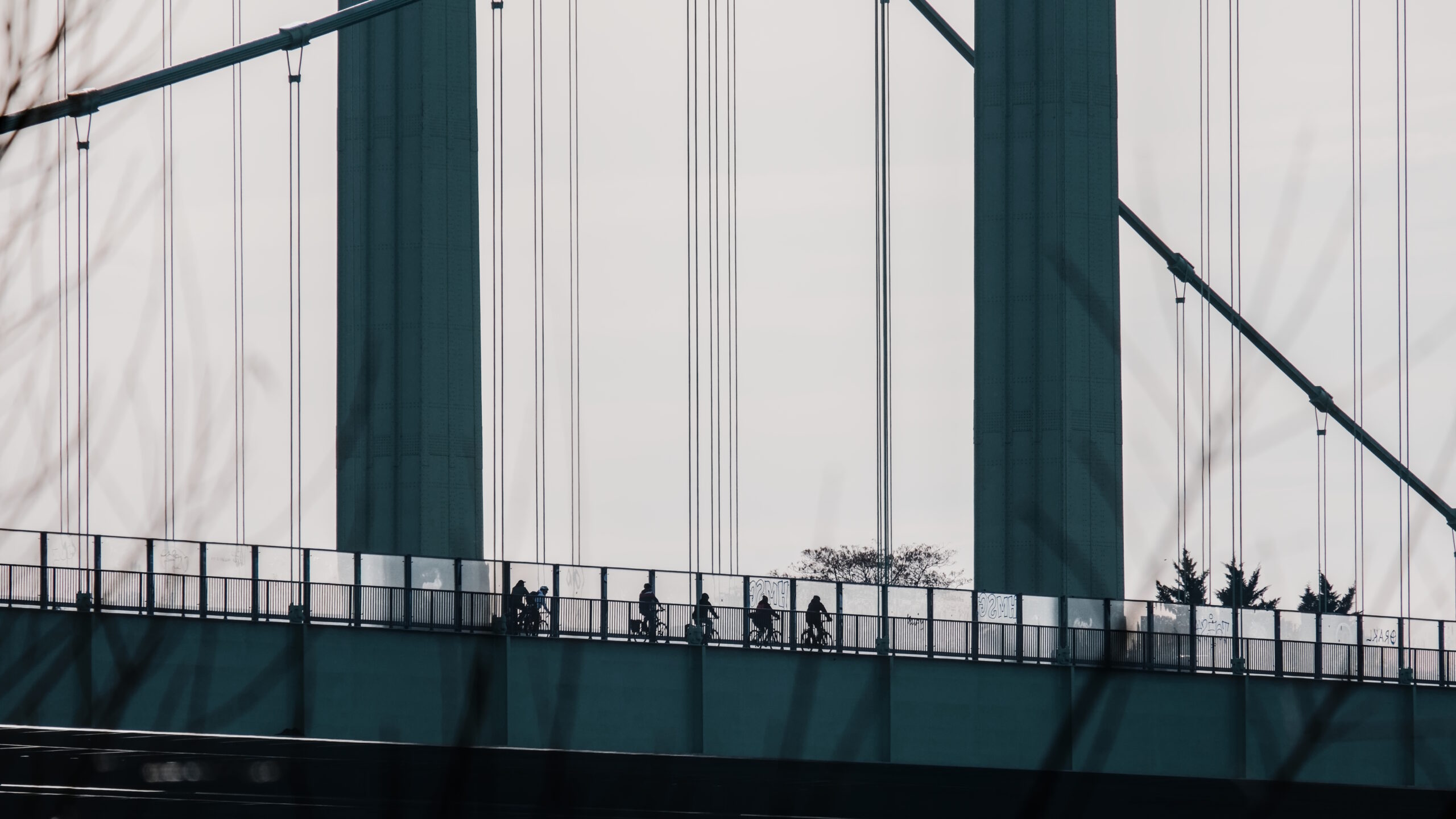 Aa group of cyclists riding over a big bridge